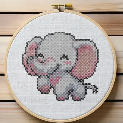 Framed in a hoop, embroidered happy elephant cross stitch