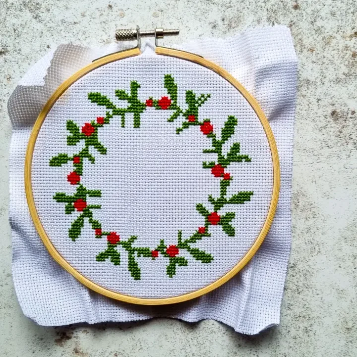 embroidered and framed Christmas wreath cross stitch