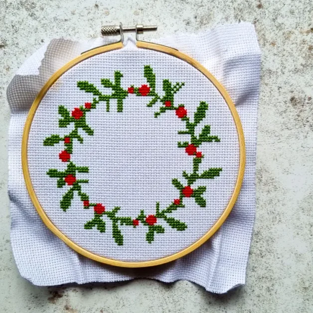 embroidered and framed Christmas wreath cross stitch