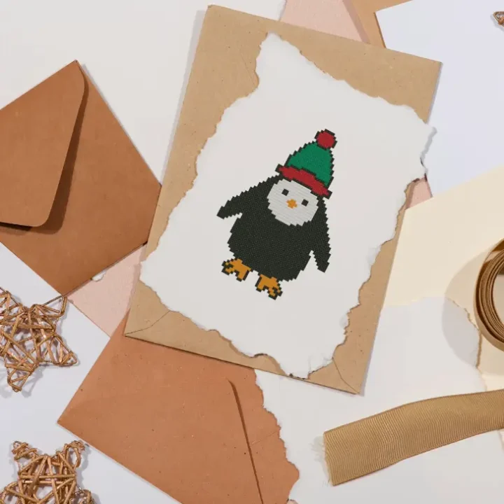 embroidered cute penguin cross stitch made into a christmas card